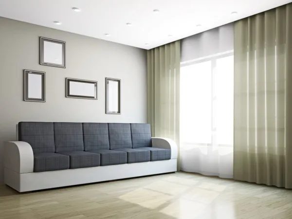 A living room with a couch and curtains