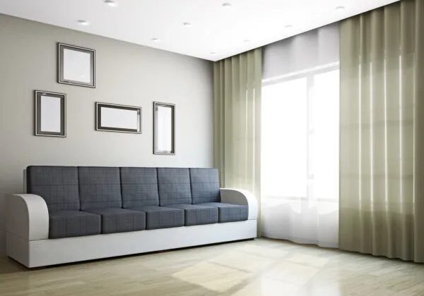 A living room with a couch and curtains